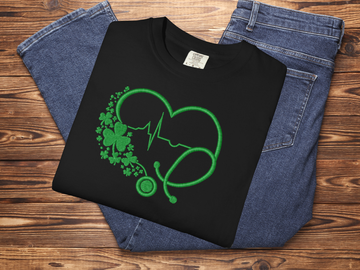 Black sweatshirt with green graphic design on a wooden surface