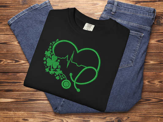 Black sweatshirt with green graphic design on a wooden surface