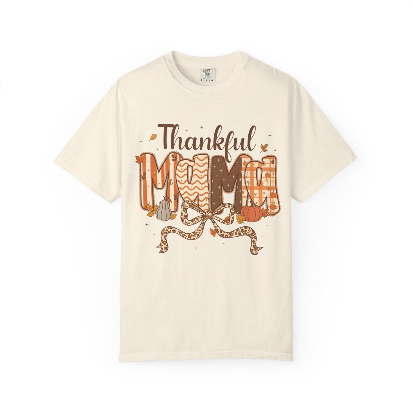 Beige t-shirt with 'Thankful Mom' text and autumn-themed graphics on a white background