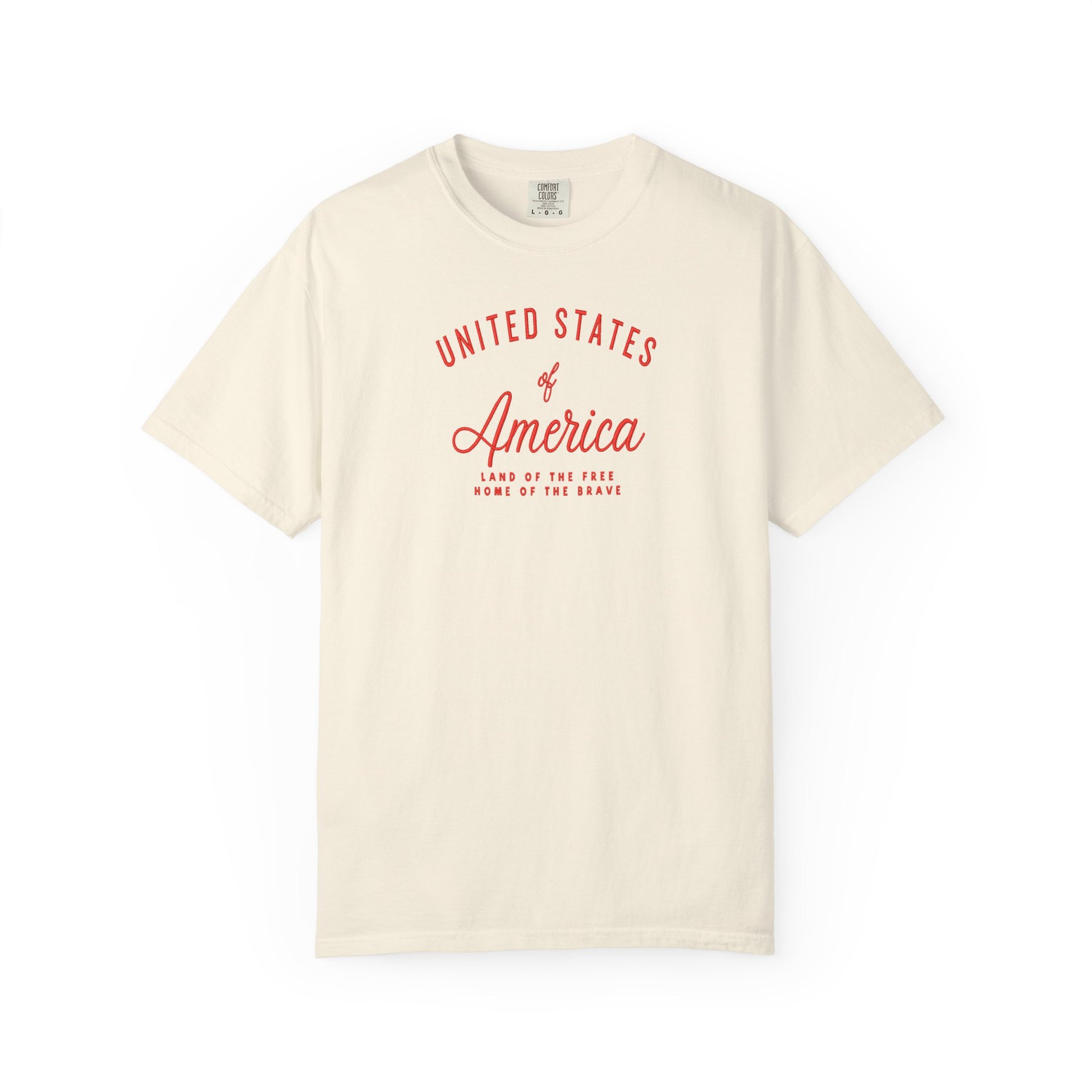 Ivory patriotic USA t-shirt featuring “United States of America” red graphic text with Land of the Free Home of the Brave design for 4th of July and Independence Day wear