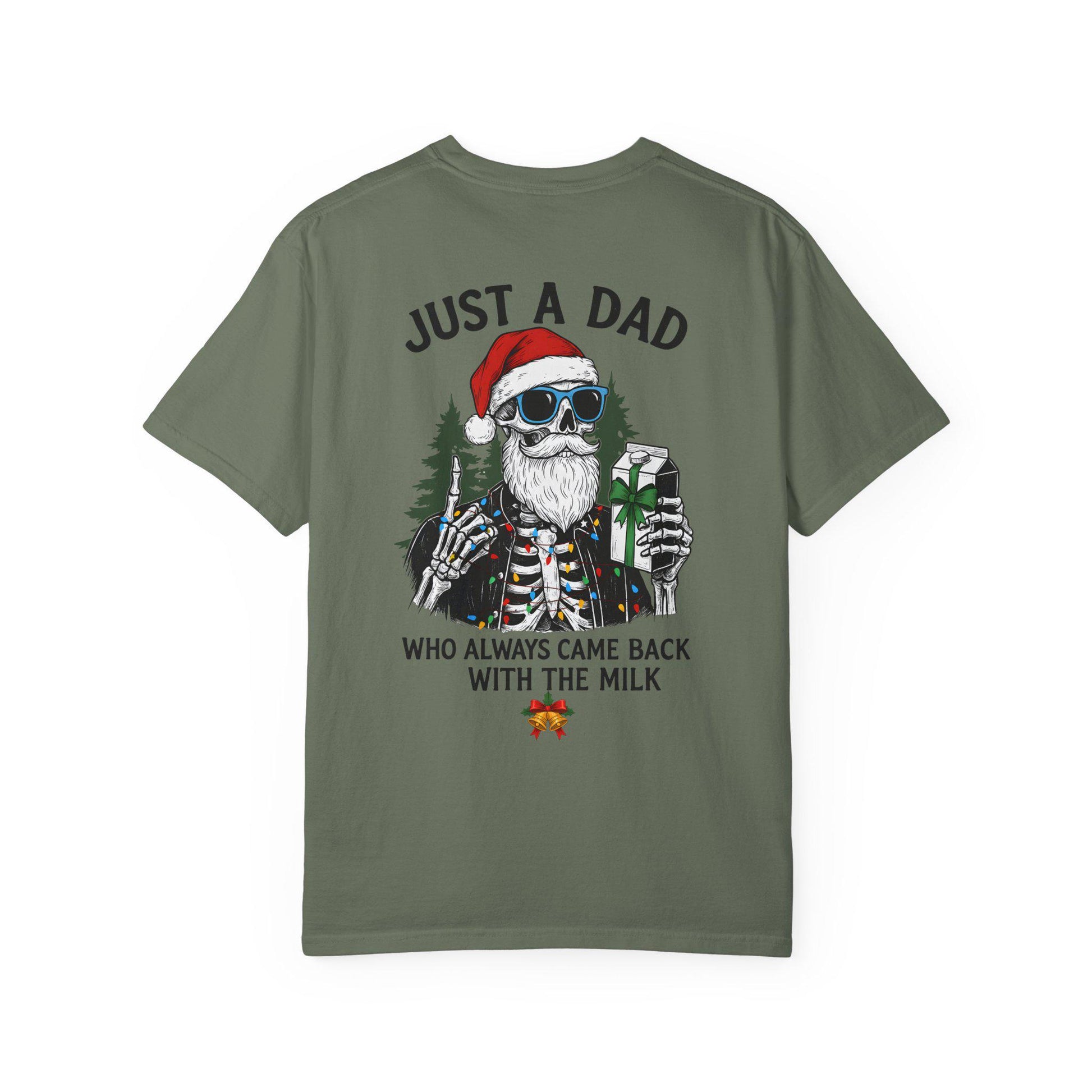 Green t-shirt with a skeleton wearing a Santa hat and sunglasses holding a gift, text 'Just a dad who always came back with the milk' on a white background.