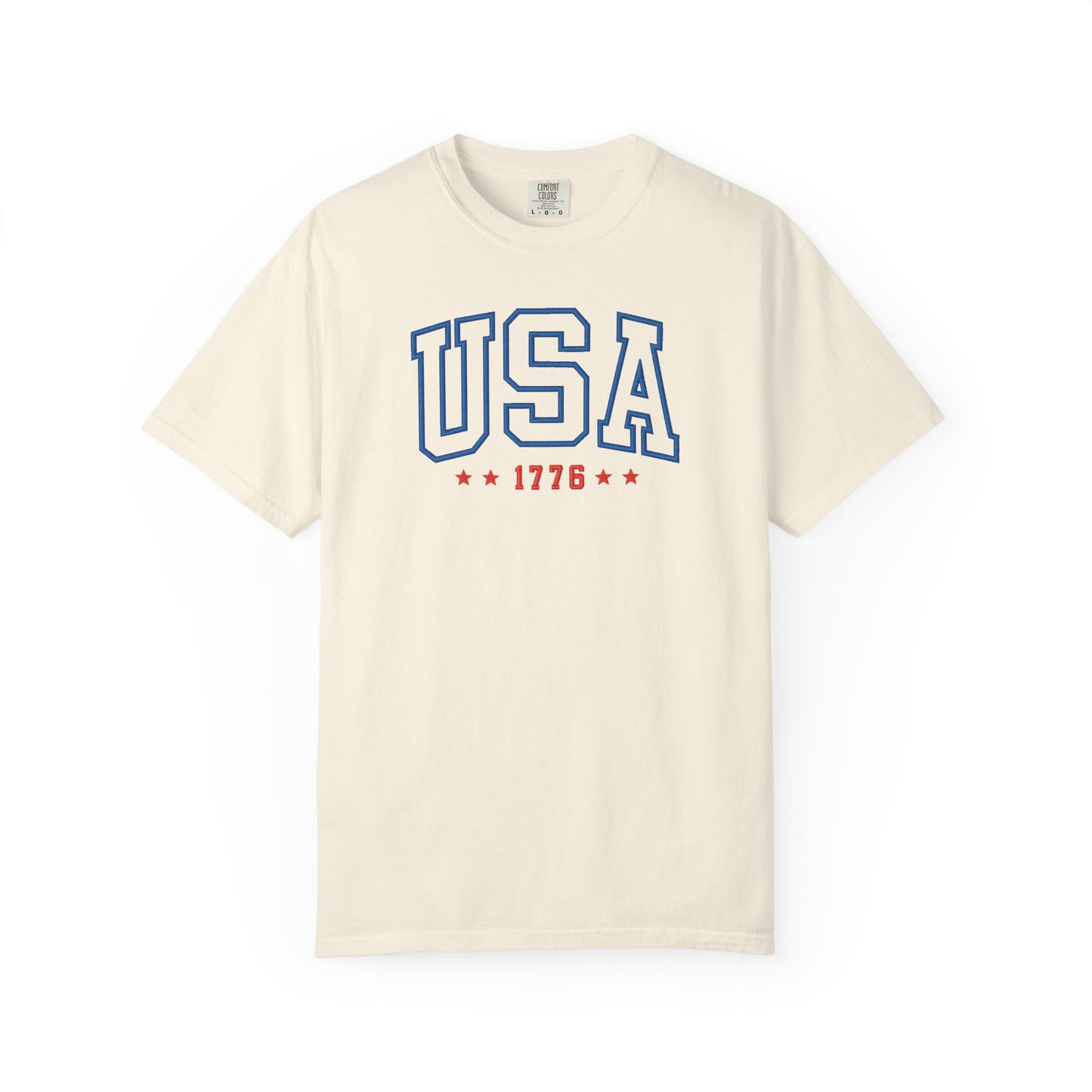 Ivory patriotic USA t-shirt featuring “USA 1776” blue graphic text with USA 1776 design for 4th of July and Independence Day wear