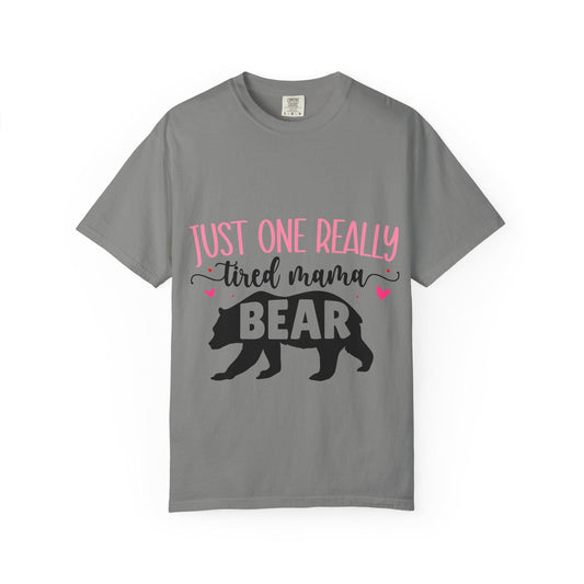 Gray Comfort Colors short sleeve t-shirt featuring the phrase “Just One Really Tired Mama Bear” in playful pink and black fonts. The design includes a bold black silhouette of a walking bear with the word “BEAR” in pink block letters inside the bear, and small pink hearts for added charm. A cozy, fun, and relatable shirt for moms, perfect for Mother’s Day, new moms, or as a comfy everyday mom life tee.