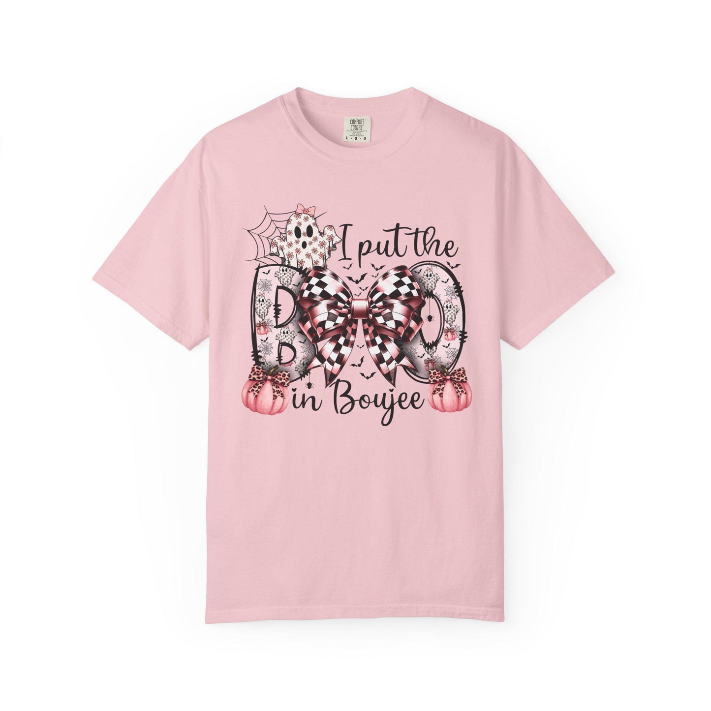 Blossom short-sleeve t-shirt with a playful Halloween-themed design that reads “I put the BOO in Boujee.” The word “BOO” is decorated with black and pink patterns, including leopard print and buffalo plaid, accented by a large checkered bow. Surrounding the text are cute seasonal details such as pink pumpkins, a ghost, bats, and a spider web, giving the shirt a stylish and boujee spooky vibe.